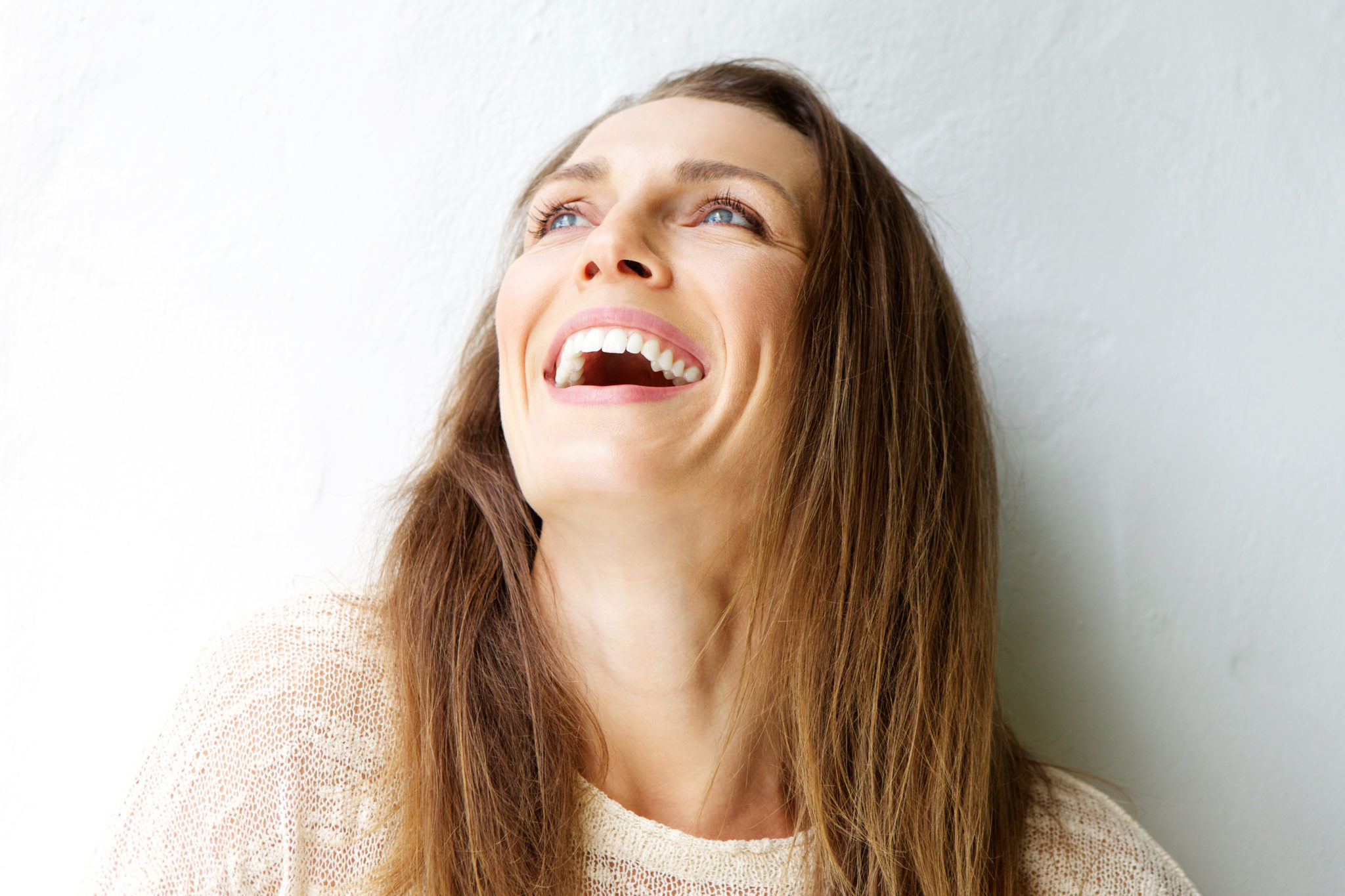 Beautiful Middle Aged Woman Laughing Against